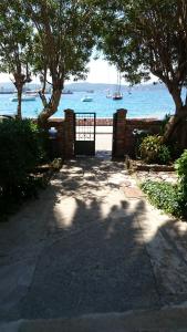 a gate with a view of the water with boats at House Grabic in Tivat