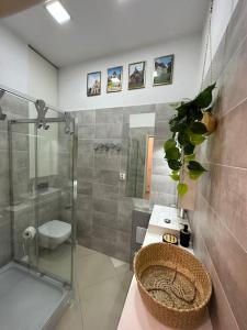 a bathroom with a sink and a toilet and a shower at Salt INN Apartments No 1 in Wieliczka