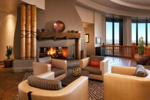 a living room with a fireplace and couches at Sheraton Grand at Wild Horse Pass in Chandler