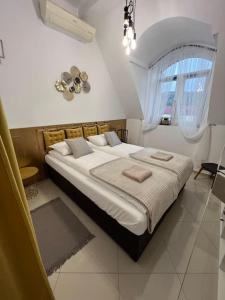 a bedroom with a large bed and a window at Salt INN Apartments No 1 in Wieliczka