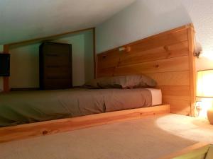 a bedroom with a bed with a large mirror at Appartement Les rousses, Jura in Les Rousses