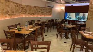 a dining room with wooden tables and chairs at Mas-wadi in Aqaba