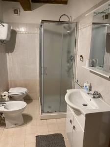 een badkamer met een douche, een toilet en een wastafel bij Casa Perla in Città di Castello