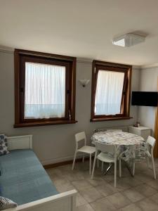 a bedroom with a table and a bed and windows at Hotel Lydia in Grado +41 photos