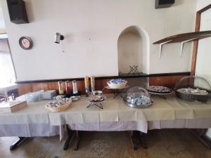 a table with several bowls of food on it at hotel le tourisme in Embrun