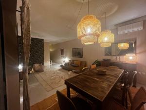 a living room with a table and a dining room at Cozy Apartment in Santa Luzia