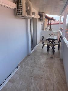 a patio with a table and chairs on a balcony at House Filippos in Sarti