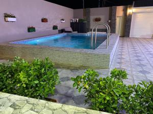 a swimming pool in the middle of a house at Elite Novkhany-Corat Villa in Corat
