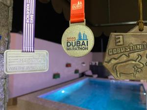 a swimming pool with two championship medals and a swimming medal at Elite Novkhany-Corat Villa in Corat