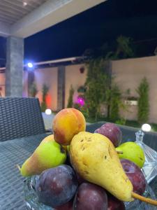 a glass bowl of fruit on a table at Elite Novkhany-Corat Villa in Corat +48 photos