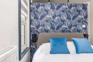 a bedroom with a blue and white patterned wall at North Laine Boutique in Brighton & Hove