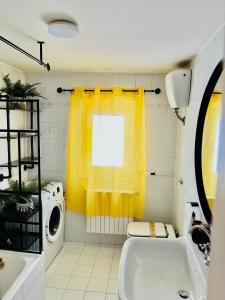 a bathroom with a sink and a washing machine at Yellow House in Teramo