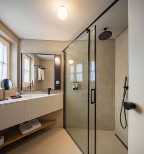 a bathroom with a shower and a sink at Casa do Fontanário Stay in Amarante