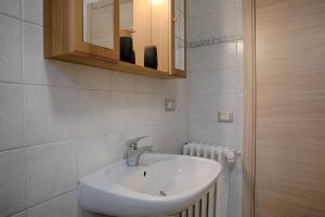 a bathroom with a sink and a mirror at BNBERNINA EXPRESS Dietro al Trenino Rosso in Tirano +12 photos
