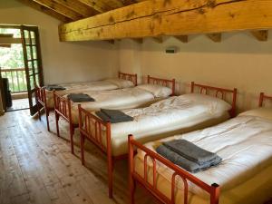 a group of four beds in a room at Baita Misonet in Comano Terme