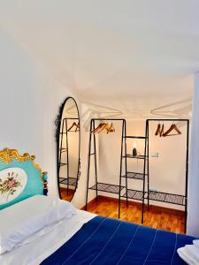 a bedroom with a bed and two mirrors at Yellow House in Teramo