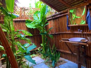 a bathroom in a bamboo house with a sink at Tongo Hill Cottages in Moalboal