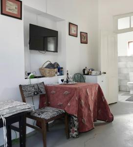 a room with a table and chairs and a television at @19 Queenstreet in Calitzdorp