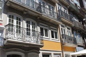 a building with balconies on the side of it at Porto with History in Porto