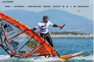 a man riding a wind sail on the water at RAQUEL'S - Habitacions i Apartaments turístics - in Sant Pere Pescador