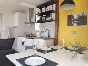 a kitchen with a table with glasses on it at A Casiña do Camiño in Baamonde +29 photos