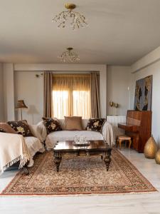 ein Wohnzimmer mit einem Sofa und einem Couchtisch in der Unterkunft Castle Villa Anavyssos in Anavyssos