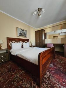 a bedroom with a large bed in a room at Dinasty Hotel 