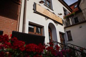 a building with a sign on the side of it at Oliwa Park Residence in Gdańsk