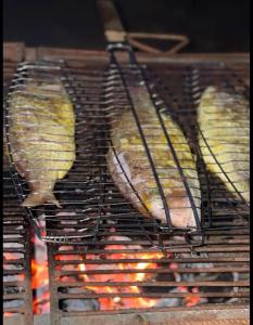 a group of food cooking on a grill at Villa Stella in Lomé