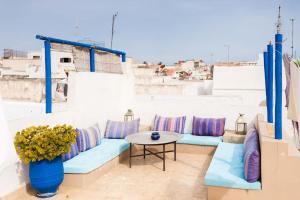 einen Balkon mit blauen Sofas und einem Tisch in der Unterkunft Riad Dar Lina in Rabat