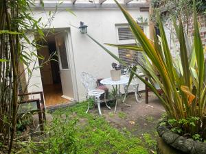 a patio with a table and chairs in a yard at French Gite Style Garden Apartment, Central Taunton in Taunton