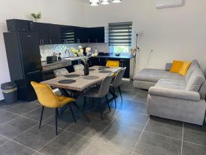 a kitchen and dining room with a table and a couch at Dóra vendégház in Letenye