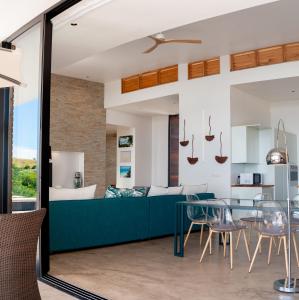 a living room with a couch and a table at PASSOT HILLS in Nosy Be