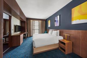 a hotel room with a bed and a desk at voco Makkah by IHG in Mecca
