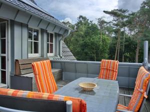 a patio with a table and chairs on a deck at Ferienwohnung MH2 "Sunrise" in Rostock