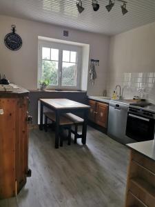 a large kitchen with a wooden table and a table sidx sidx sidx sidx at Les gîtes de Blandine in Peumérit +22 photos