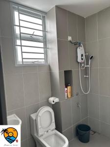 a bathroom with a white toilet and a shower at ZZZ HOMESTAY SKUDAI in Skudai