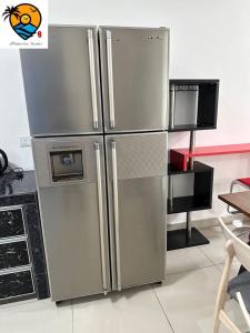 a large stainless steel refrigerator in a kitchen at ZZZ HOMESTAY SKUDAI in Skudai