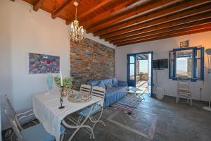 a living room with a table and a couch at Tzados Sunny Villa in Kariá +11 photos