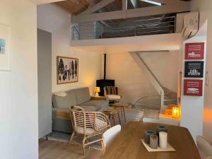 a living room with a couch and a loft at Maison « Shaka » in Capbreton
