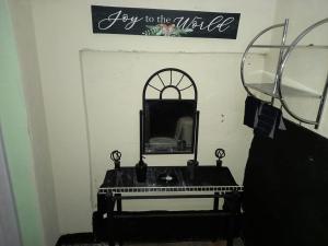 a mirror and a piano in a room at Buckingham Villa & Suites Room # 6- Garden View in Buff Bay +5 photos