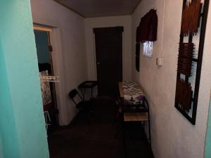 a small room with a table and a door at Buckingham Villa & Suites Room # 6- Garden View in Buff Bay