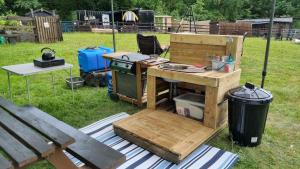 a picnic table with a sink and a grill at Route 47 Glamping Bell Tents in Cross Hands