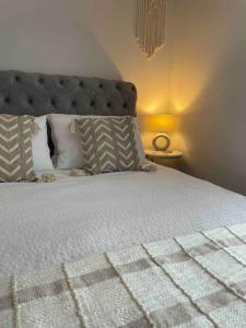 a bedroom with a large white bed with pillows at The Claremont, Seaford, South Downs, Seaside Town in Seaford