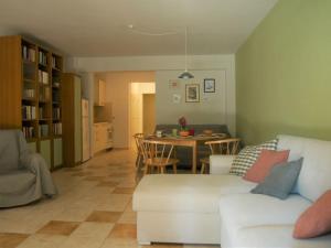 a living room with a white couch and a table at Green Cozy Nest in Paleo Tsifliki