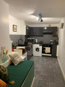 a small kitchen with a washer and dryer at Richard III Luxury apartment in Leicester