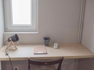 a desk with a laptop and a lamp on it at La Maison de Jeanne in Capvern