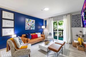 a living room with a blue wall at Modern Swank Luxury Aptmins The Battery3bd2br in Atlanta