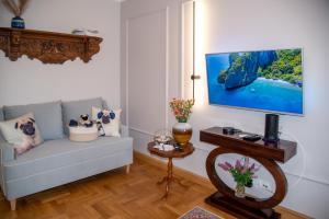 a living room with a couch and a flat screen tv at Maya's Flats & Resorts 102 - PREMIUM 3 rooms apartment near the sea in Gdańsk