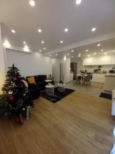 a living room with a christmas tree in a living room at Superbe appartement moderne en rez-de-chaussée in Ozoir-la-Ferrière